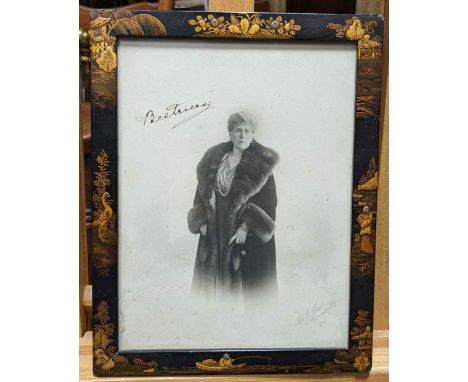 A Chinoiserie black and gold lacquer picture frame decorated with animal and landscape vignettes in relief, with a signed ima