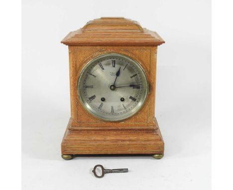A 19th century light oak and cut brass cased bracket clock, having a French movement, the dial inscribed examined by Dent, Lo