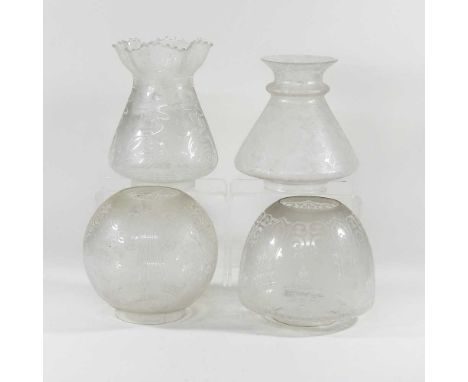A collection of four glass oil lamp shades, with etched decoration, 23cm high (4)All are dirty. Circular shade has a small fl
