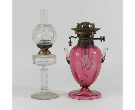 A cranberry glass oil lamp, together with a cut glass oil lamp and shade, 29cm high (2)Cranberry lamp - some chips around the