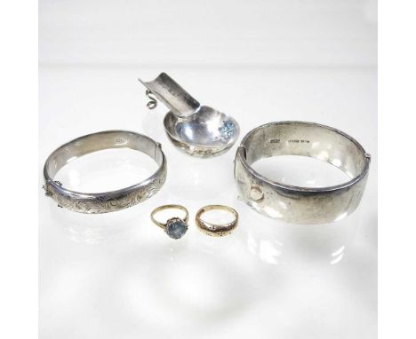 A 9 carat gold dress ring, 2.6g, size R, together with another, 3g, size L, two hinged silver bangles and a silver spoon rest