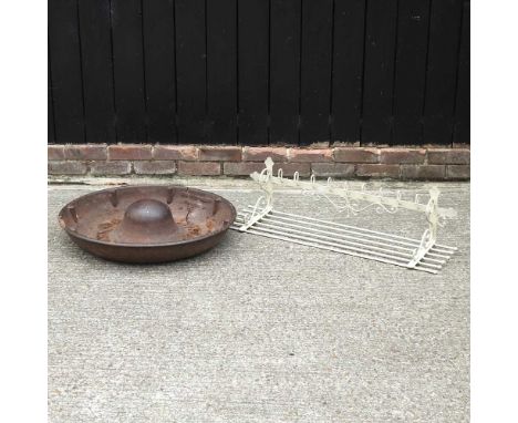 A cast iron pig trough, 74cm diameter, together with a white painted metal coat rack (2)