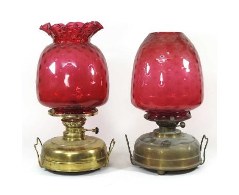 Two 19th century brass oil lamps, each with a ruby glass shade, 46cm high (2)