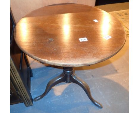 Circular tilt top table on tripod base