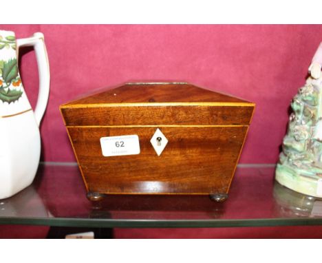 A 19th Century mahogany and boxwood strung tea caddy of sarcophagus shape