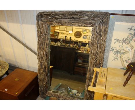 A large wall mirror with wooden surround