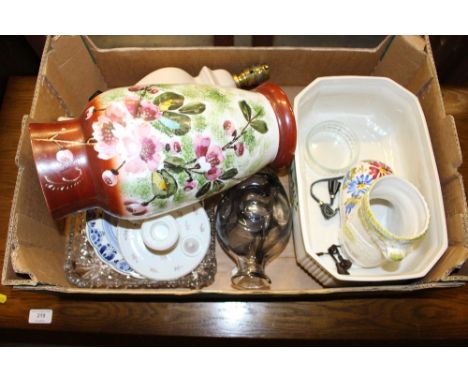 A box containing a table lamp and shade; a floral decorated glass vase and other sundry china