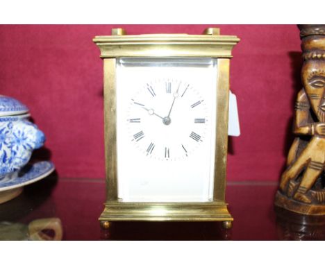 A brass cased carriage clock with key