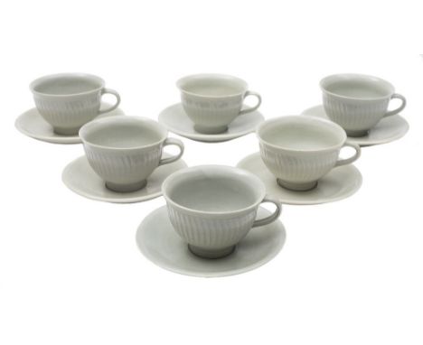 * David Leach (1911-2005) a porcelain tea service: comprising six cups with exterior fluting and six saucers under celadon gl