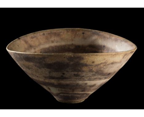 *Lucie Rie (1902-1995) a stoneware bowl: of 'squeezed' circular form decorated with banded brown, cream and green matt glazes
