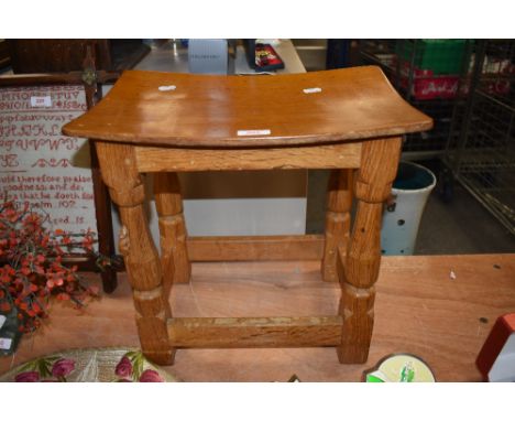 From the workshop of Robert Thompson Mouseman a Lakeland Arts and Crafts golden oak stool, having typical mouse signature.