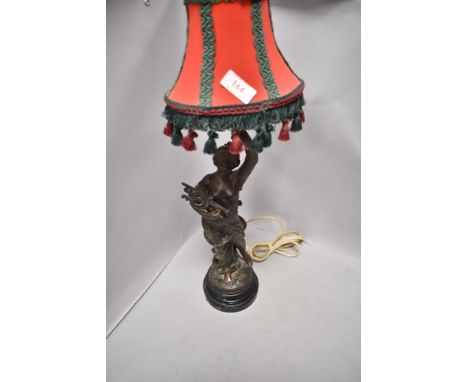 A Victorian French spelter lamp base in the form of a maiden with lute holding torch, appears in good condition with no break