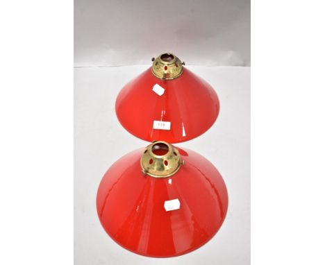 A pair of conical ceiling light shades in red and white glass having original gallery
