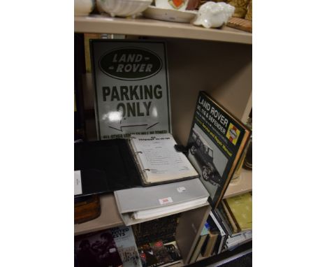 A selection of Land Rover items including Defender service manual, Ninety. One Ten Workshop manual and parking sign