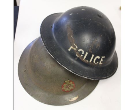 WW2 British Police Helmet dated 1938 white with white lettering and a WW2 NFS Helmet with NFS decal to front. 411180 painted 