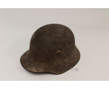 WW1 Imperial German M1916 pattern steel helmet. Shell has original shrapnel damage to the side. Makers marks "ET" for "Eisenh