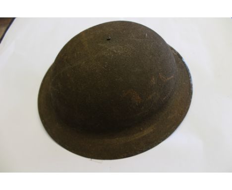 WW1 US made Brodie helmet. Original heavy textured paintwork. Complete with original liner which retains part of paper label 