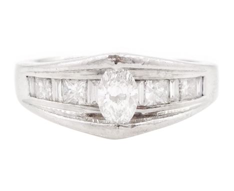 Platinum diamond ring, the marquise cut diamond of approx 0.45 carat, raised above channel set, princess and baguette cut dia