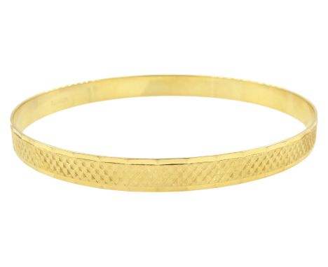 18ct gold bangle, with engine turned decoration, stamped 750Condition Report:Approx 13.3gm, inner circumference = 20cm, a few