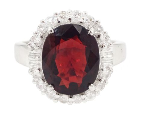 9ct white gold oval cut garnet and round cut white topaz ring, hallmarkedCondition Report:Approx 5.85gm, size N, head = 16.5m