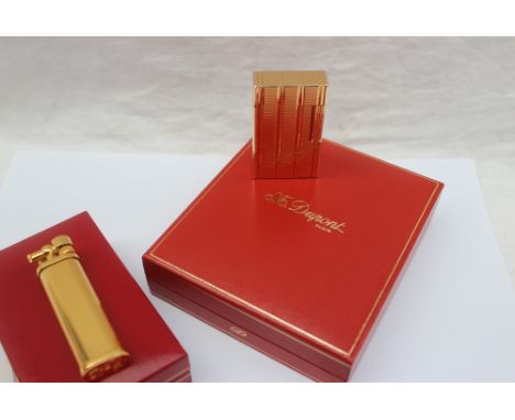 An S.J. Dupont gold plated lighter, No.17JJl55, cased together with a Corona Slim Boy plated lighter, boxed CONDITION REPORT: