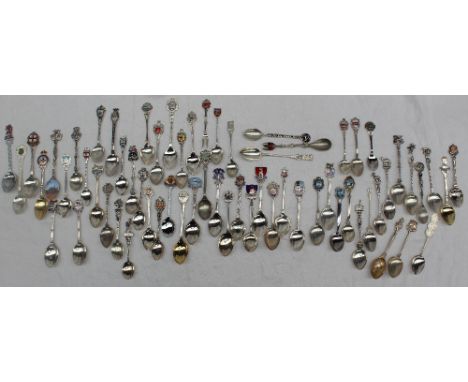 A large collection of white metal and enamel decorated souvenir spoons