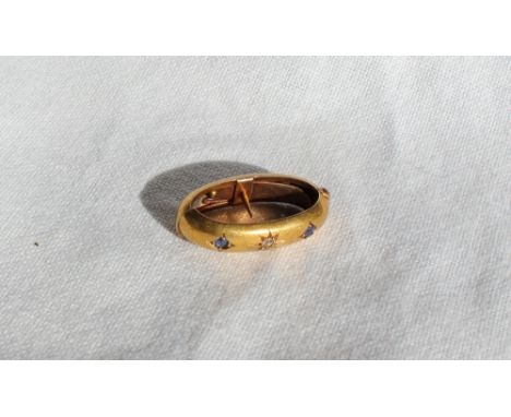 A 15ct yellow gold sapphire and diamond set scarf ring, of oval form, approximately 3.9 grams