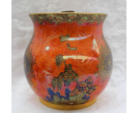 A Carltonware style tobacco jar and cover, decorated with birds of paradise and trees to a mottled orange ground, black print