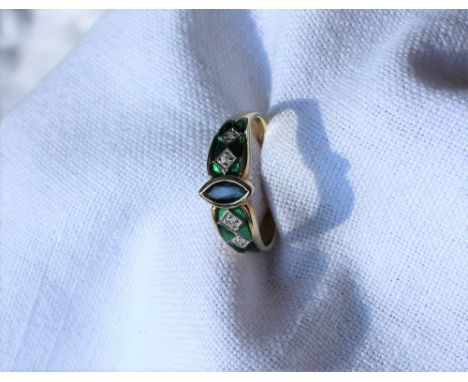 A sapphire, diamond and green enamel ring, set with a pointed oval sapphire and four diamonds with green enamel surround to a