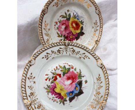 A pair of Chamberlain Worcester pottery plates, painted to the centre with a spray of garden flowers, the edge with gilt deco