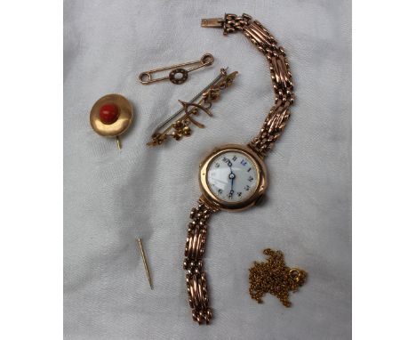 A 9ct gold Lady's wristwatch, the circular enamel dial with Arabic numerals in a 9ct gold case and expanding bracelet togethe