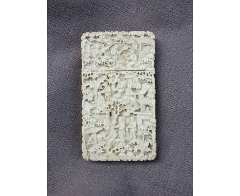 A Cantonese Ivory card case, carved with figures, pagodas and trees, 9.5 x 5.5 x 1.5cm CONDITION REPORT: Some hairline cracks