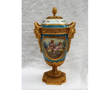 A 19th century Sevres style porcelain and ormolu mounted twin handled vase and cover, the domed cover with a pineapple finial