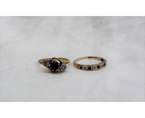 A sapphire and diamond ring set with central sapphire and two diamonds to a white metal claw setting and 18ct yellow gold sha
