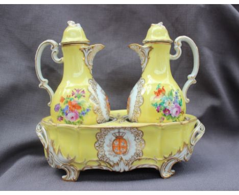 A 19th century continental porcelain oil and vinegar set in an oval stand, painted with flowers and leaves to a yellow ground