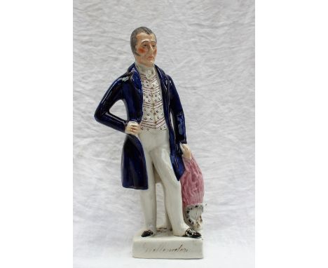 A 19th century Staffordshire figure of Wellington, in a blue frock coat on a D shaped base, 33cm high 