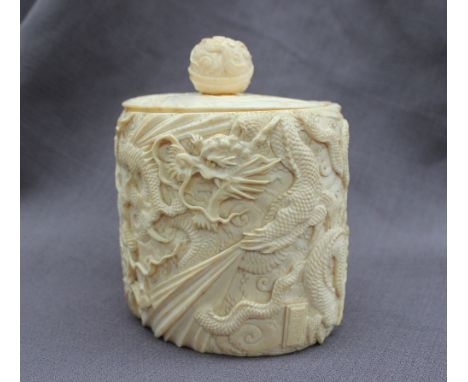 A late 19th / early 20th century Chinese carved ivory box and cover of oval form, the lid with a ball finial,  carved with dr