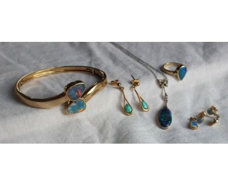 A 9ct yellow gold hinged bangle with opal panels together with a pair of 9ct yellow gold opal earrings, a pair of diamond and