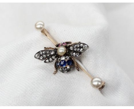 A sapphire, diamond and ruby bar brooch, in the form of a Bee, set with rose cut diamonds, a band of three sapphires to the t