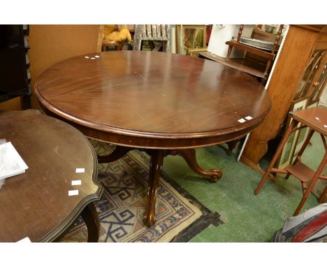 A Victorian mahogany tilt top table, oval top, cockbeaded frieze, compressed globular column, four cabriole legs, ceramic cas