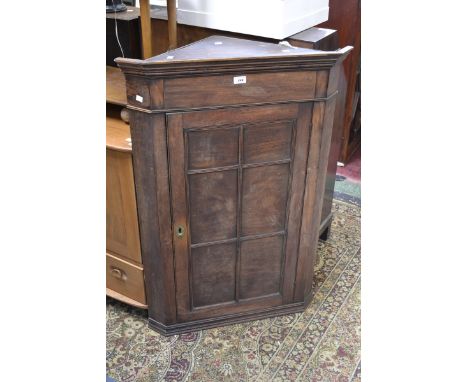 A 19th century flat front corner cupboard, six panel door, serpentine shelf interior  