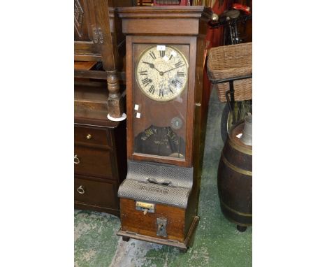 A National Time Recorder Co. Ltd. clocking in machine, oak case with cast iron fittings.