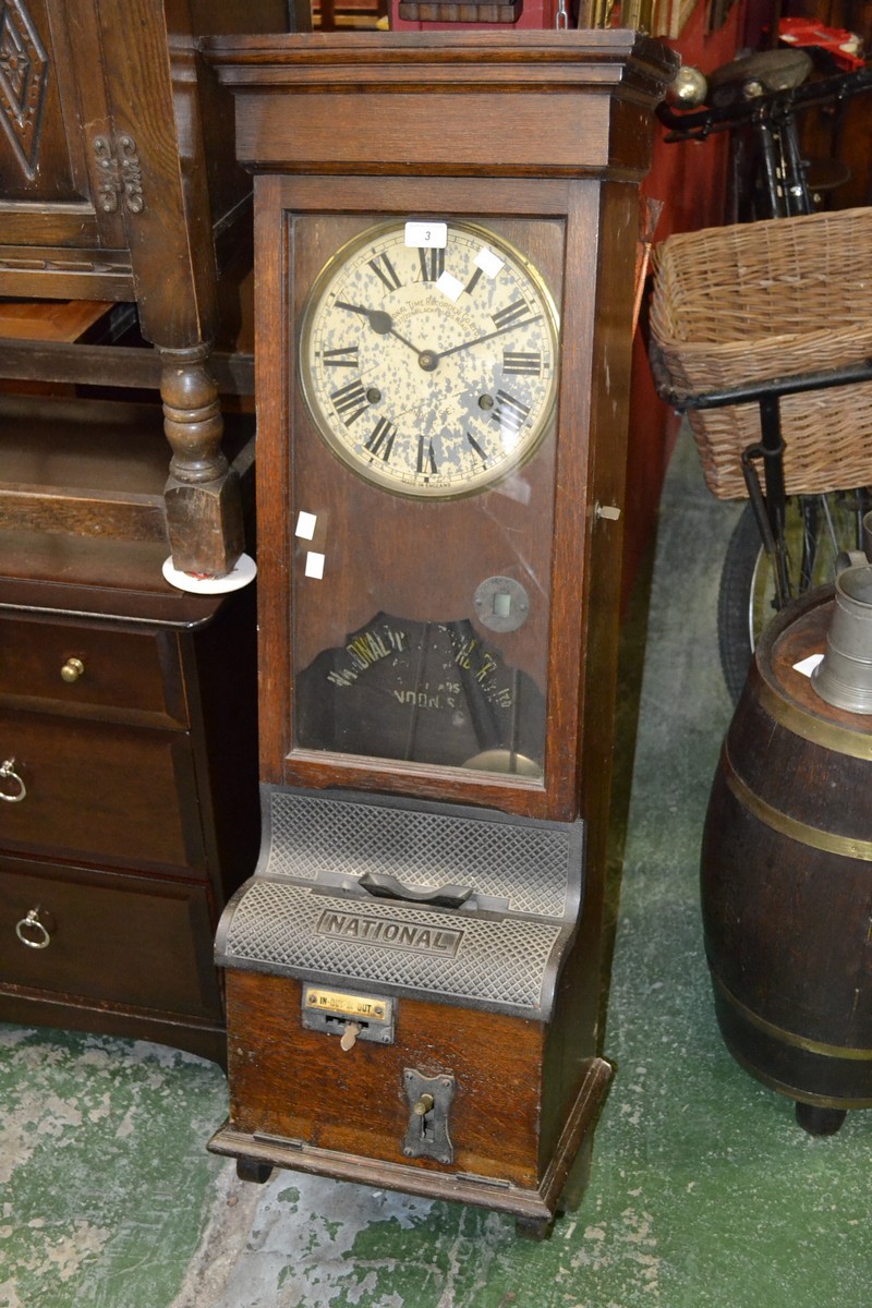 A National Time Recorder Co. Ltd. clocking in machine, oak case with