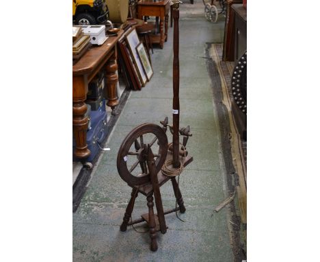 A spinning wheel converted to a standard lamp.