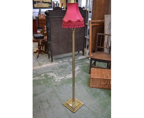 A contemporary brass standard lamp, fluted column, stepped square socle and base.