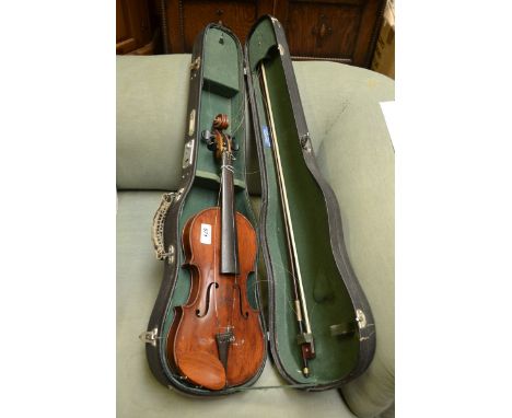 A violin, the two-piece back 33.5cm long excluding button, paper Stradivarius label, ebony tuning pegs, 56cm long overall, ea