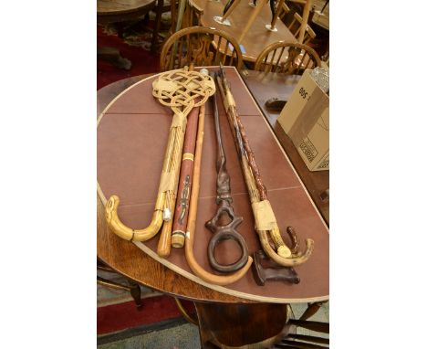 A walking stick including a horn handle; a carpet beater 