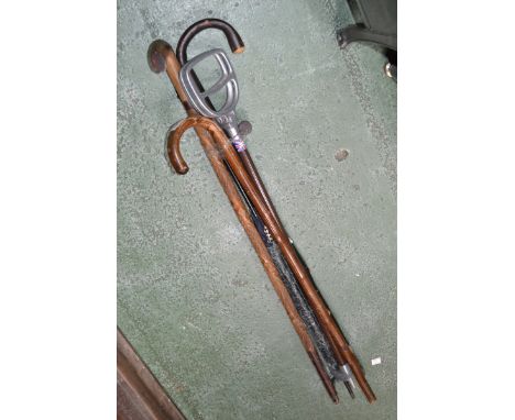 A horn handle parasol; walking sticks; a shooting stick (5)