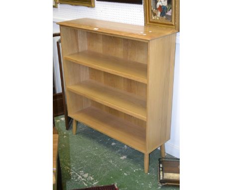 An Ercol style light oak three tier bookcase.