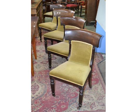 Four William IV mahogany dining chairs, curved top rail, padded back and seat, turned and lobed forelegs, ceramic casters.